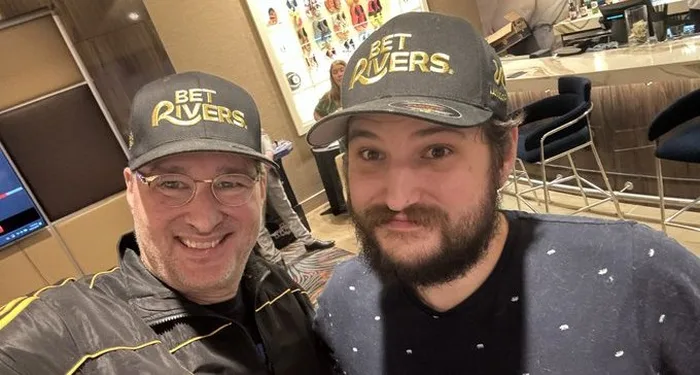 Phil Hellmuth With His Son Phil Hellmuth and one of his sons smiling in matching caps in a selfie taken at a poker room