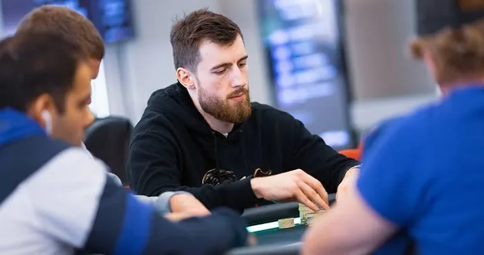 Wiktor Malinowski at the Table Wiktor Malinowski in a black hoodie at a live poker table