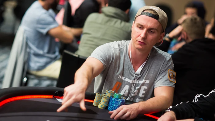 Benjamin Bencb Rolle live tournament Benjamin Rolle reaching for chips during a live poker tournament