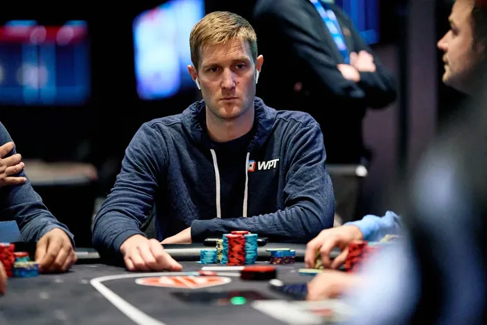 Brad Owen at a WPT event Brad Owen in a WPT hoodie with a stack of chips at the table