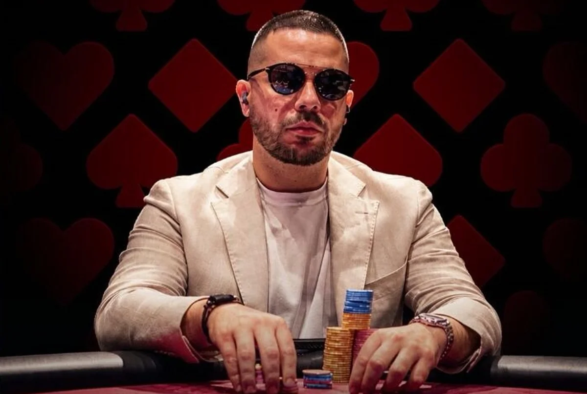 Farid Jattin in sunglasses and a cream blazer at a poker table with chips in front of him