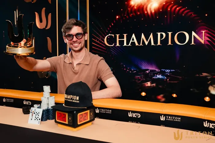 Fedor Holz holding the Triton Poker Series champion trophy