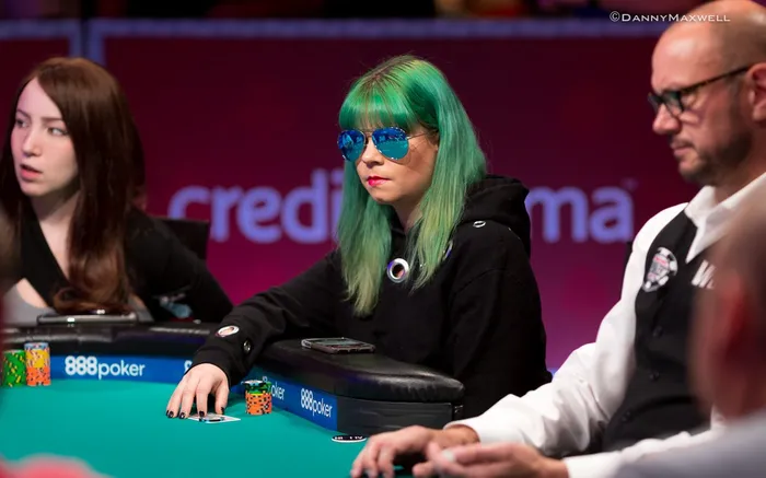 Annette Obrestad at a WSOP poker event Annette Obrestad with green hair and blue sunglasses at a WSOP poker table