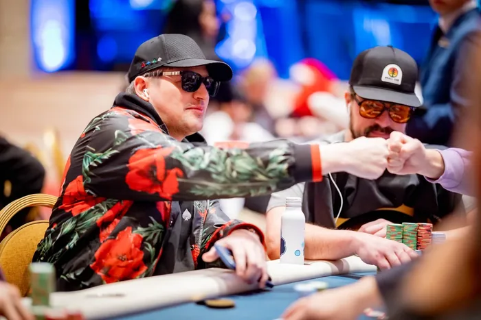 Joe Ingram at a Live Tournament Table Joe Ingram bumping fists with another player at a tournament table