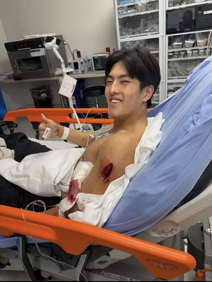 Kevin Gao in Hospital After the Alleged Lynne Ji Stabbing Kevin Gao giving a thumbs-up from a hospital bed with a wound to his right shoulder, after the alleged Lynne Ji stabbing