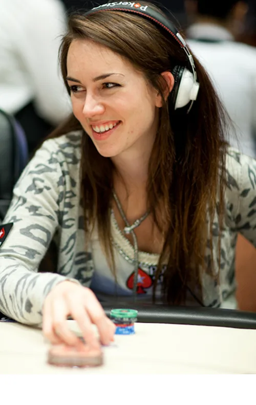 Liv Boeree Poker Player Portrait Liv Boeree smiling at a poker table wearing PokerStars gear and headphones
