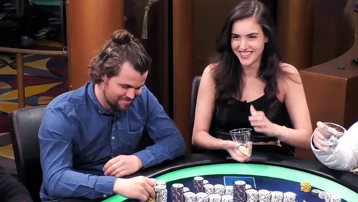 Magnus Carlsen and Alexandra Botez at the Poker Table Chess world champion Magnus Carlsen and streamer Alexandra Botez laughing at a Hustler Casino Live poker table behind stacks of chips