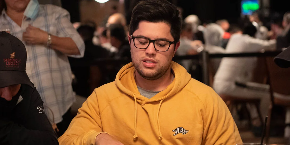 Mariano Grandoli at a live poker table Mariano Grandoli seated at a live poker table in a yellow hoodie