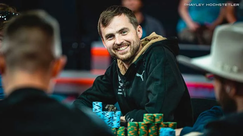 Martin Kabrhel smiling behind his chips at the WSOP Martin Kabrhel smiling at the table behind stacks of chips during a WSOP event