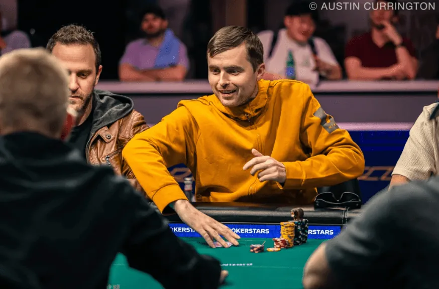 Martin Kabrhel talking to an opponent mid-hand Martin Kabrhel gesturing and speaking to an opponent during a hand at a poker table