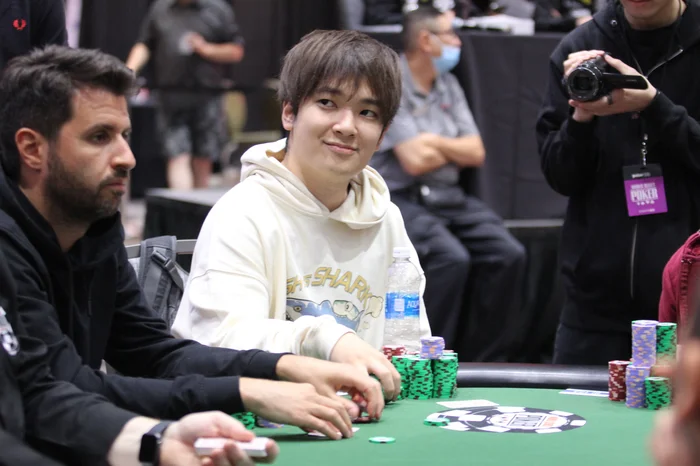 Masato Yokosawa seated at a WSOP tournament table with a large stack of chips