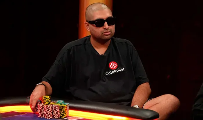 Nik Airball wearing a CoinPoker branded shirt at the poker table