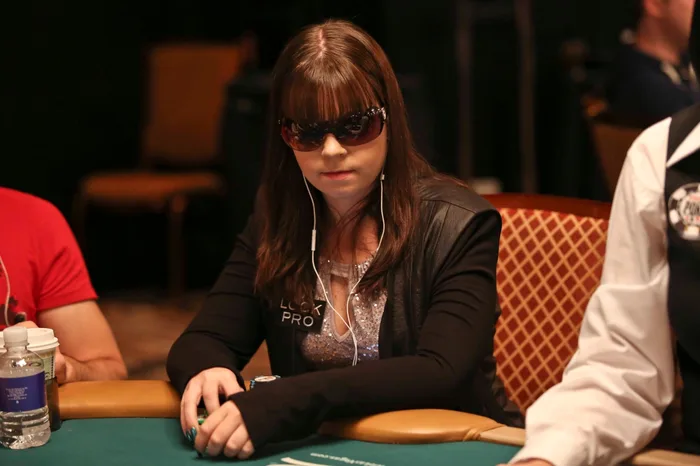 Annette Obrestad at the WSOP wearing sunglasses and a Lock Poker Pro patch during her early career