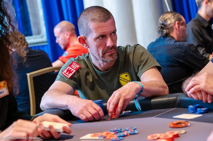 Gus Hansen competing in a Winamax-sponsored poker tournament wearing his Team Pro patch