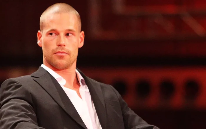 A young Patrik Antonius in a suit during his early poker career