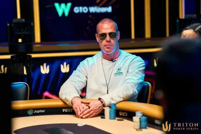 Patrik Antonius in sunglasses at a Triton Poker Series feature table
