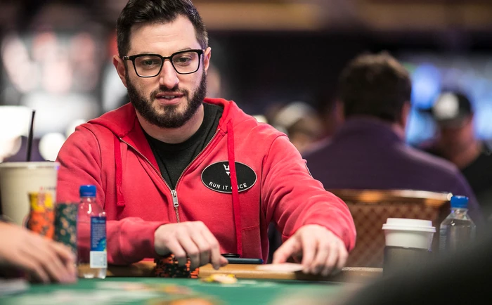 Phil Galfond in Run It Once Colours Phil Galfond wearing a Run It Once hoodie at a poker table