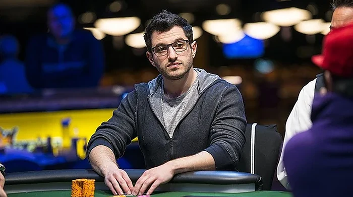 Phil Galfond at a WSOP Tournament Table Phil Galfond seated at a WSOP tournament table in a grey hoodie