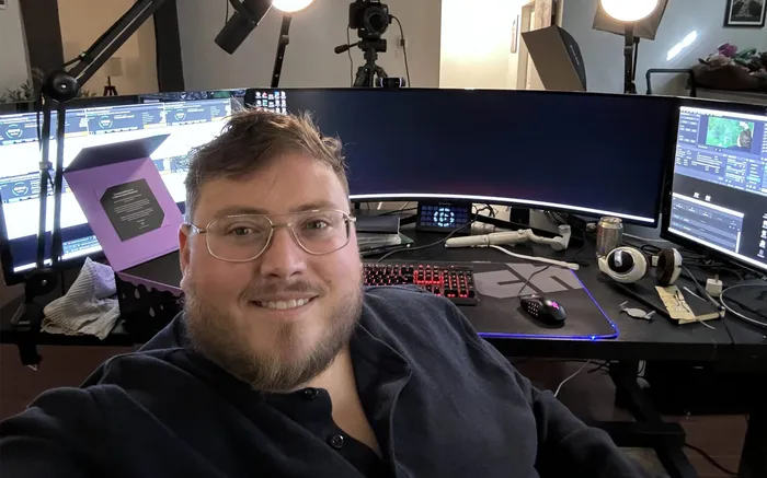 Poker content creator streaming and editing setup Poker content creator at a multi-monitor streaming and editing setup with studio lights and camera