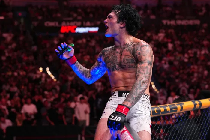 Tommy McMillen celebrates a UFC win ACR Poker ambassador Tommy McMillen celebrates on top of the cage after a UFC Fight Night win