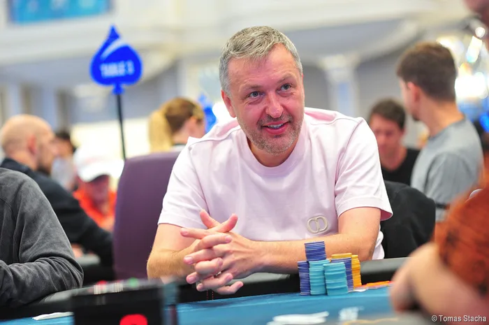 Tony G seated at a poker tournament table with stacks of chips in front of him