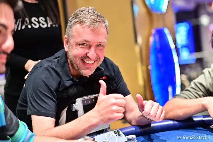 Tony G giving a thumbs up and smiling at a poker table during a tournament