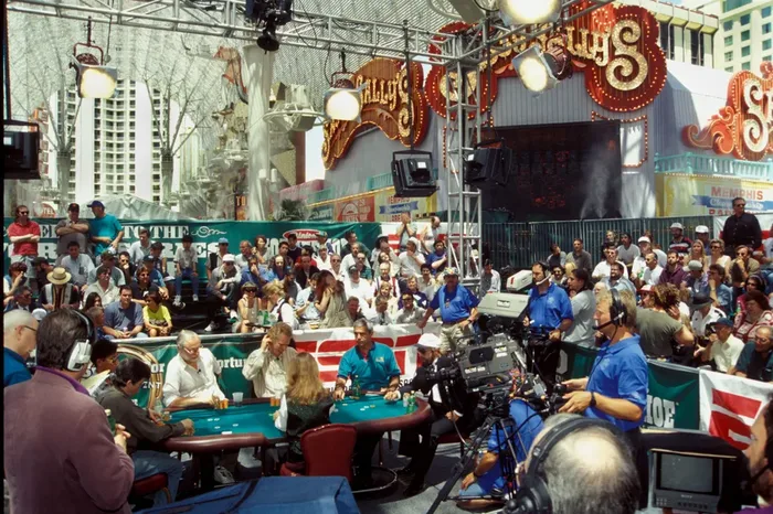 WSOP Main Event outdoor final table on Fremont Street with ESPN coverage WSOP Main Event final table played outdoors on Fremont Street with ESPN cameras and crowd in the 1990s