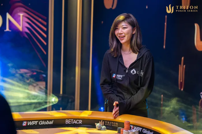 Xuan Liu smiling at the 2025 Triton Montenegro final table wearing a WPT Global patch