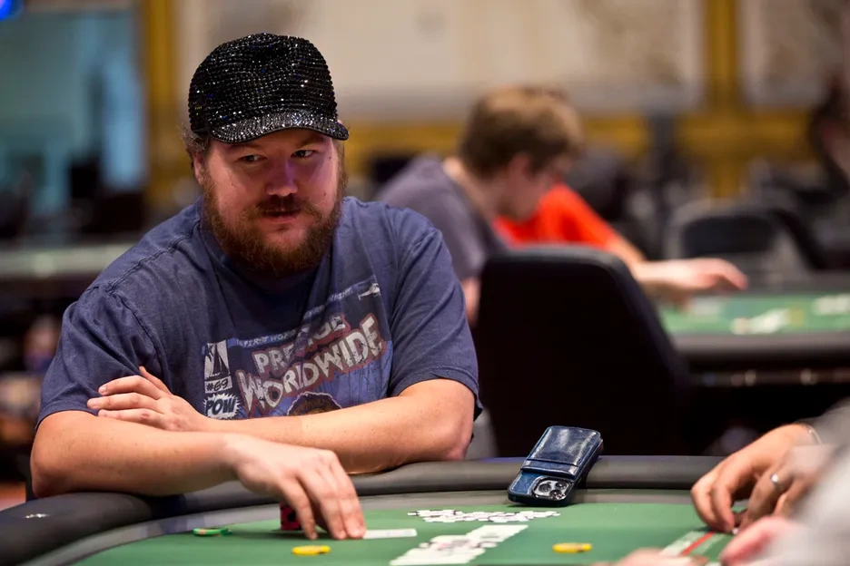 Shaun Deeb, 8x WSOP bracelet winner and WSOP 2025 Player of the Year, focused at the poker table in black cap. 