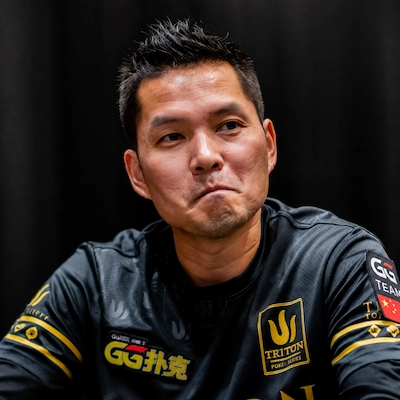 Ren Lin at a Triton Poker Series event wearing a black and gold jersey