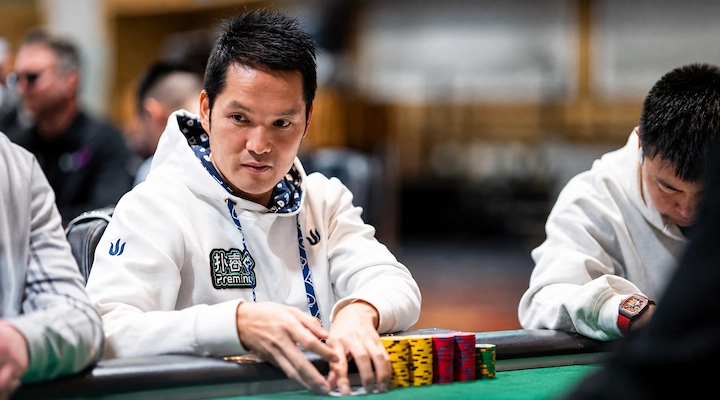 Ren Lin stacking chips during a live poker tournament hand